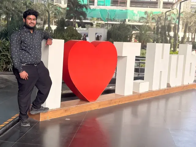 Vahini team member beside the I Love T-Hub sign
